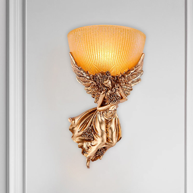 Single angel wall lamp with bulb, rustic golden resin wall lamp with amber-colored ribbed glass shade, right