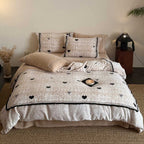 Quilted bedding set with heart and bow appliqué