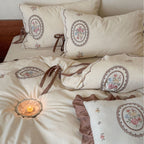 Romantic cotton-linen bedding set with embroidered flower medallions and ruffles