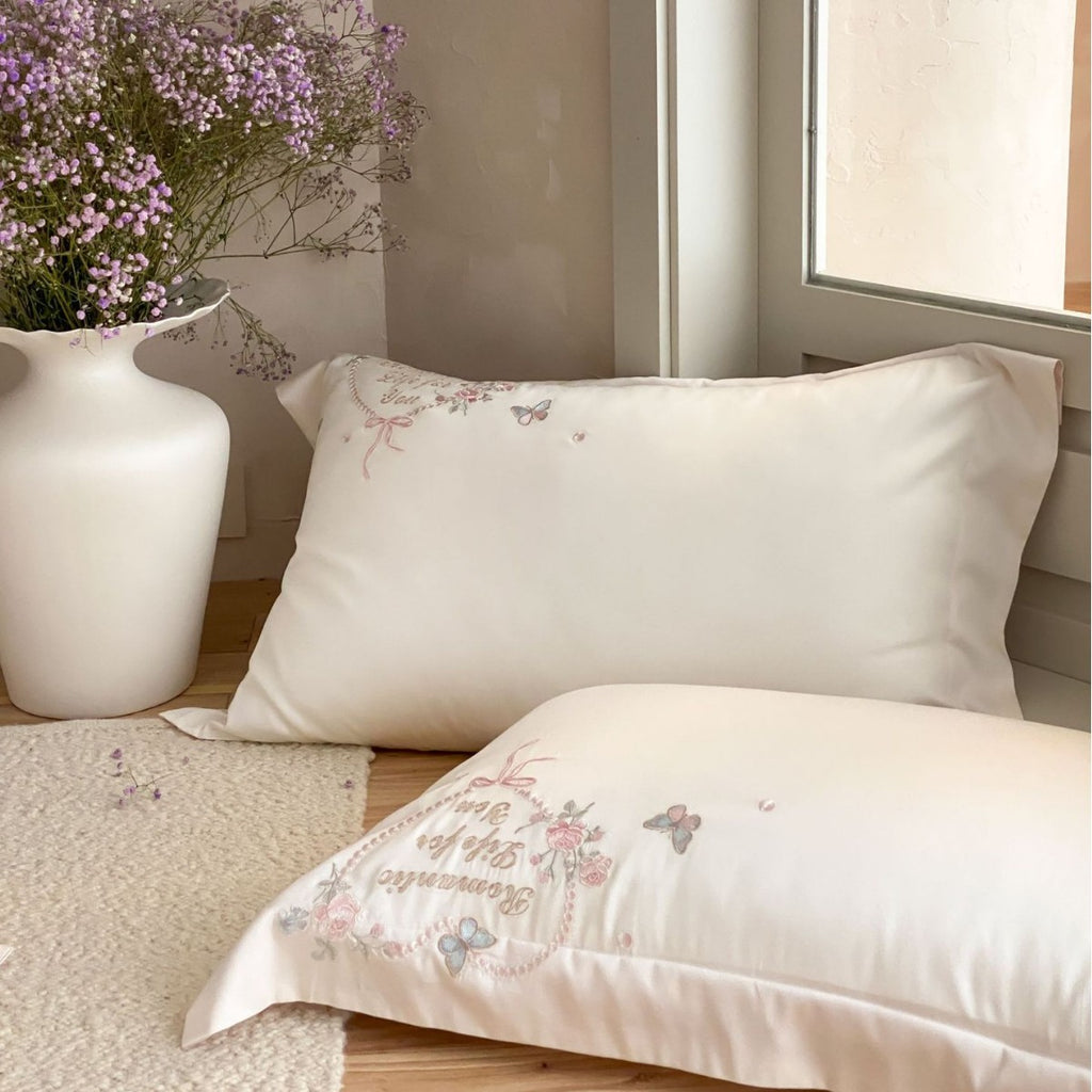 Luxurious embroidered cotton satin bedding set with delicate butterfly and flower appliqués