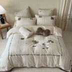 striped cotton bedding set with embroidered teddy bear appliqués and button closure