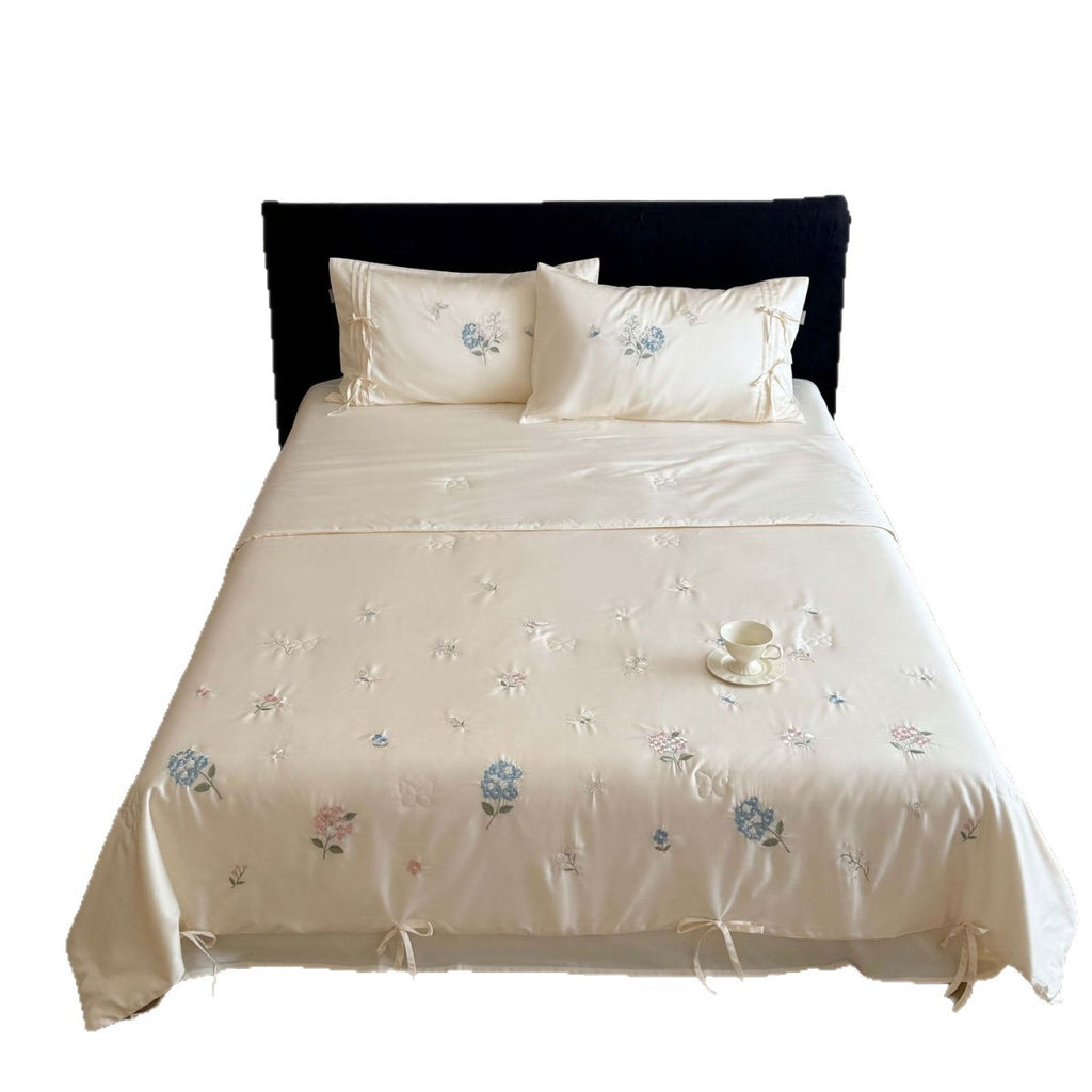 Satin bedding set with floral embroidery, tie ribbons, and silky glossy finish