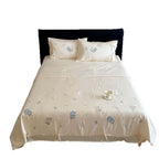 Satin bedding set with floral embroidery, tie ribbons, and silky glossy finish