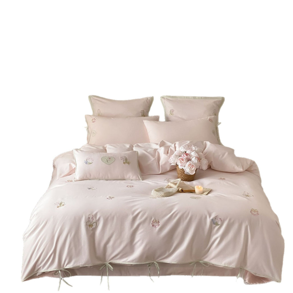 Embroidered cotton satin bedding set with decorative ribbons and floral appliqués