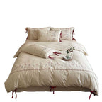 Embroidered bed linen set with lace trim and decorative bows