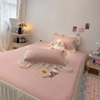 Quilted bedspread with ruffle and delicate floral quilting