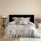 Bedding set made of cotton percale with frill hem, floral embroidery, and decorative ribbons