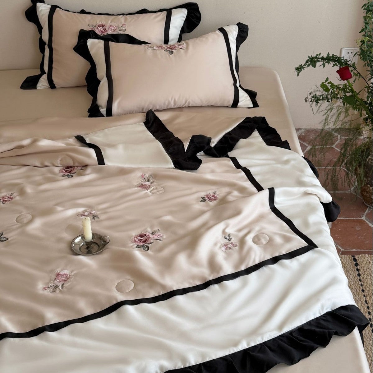 Satin duvet cover set with subtly embroidered roses, contrasting piping and ruffled hem