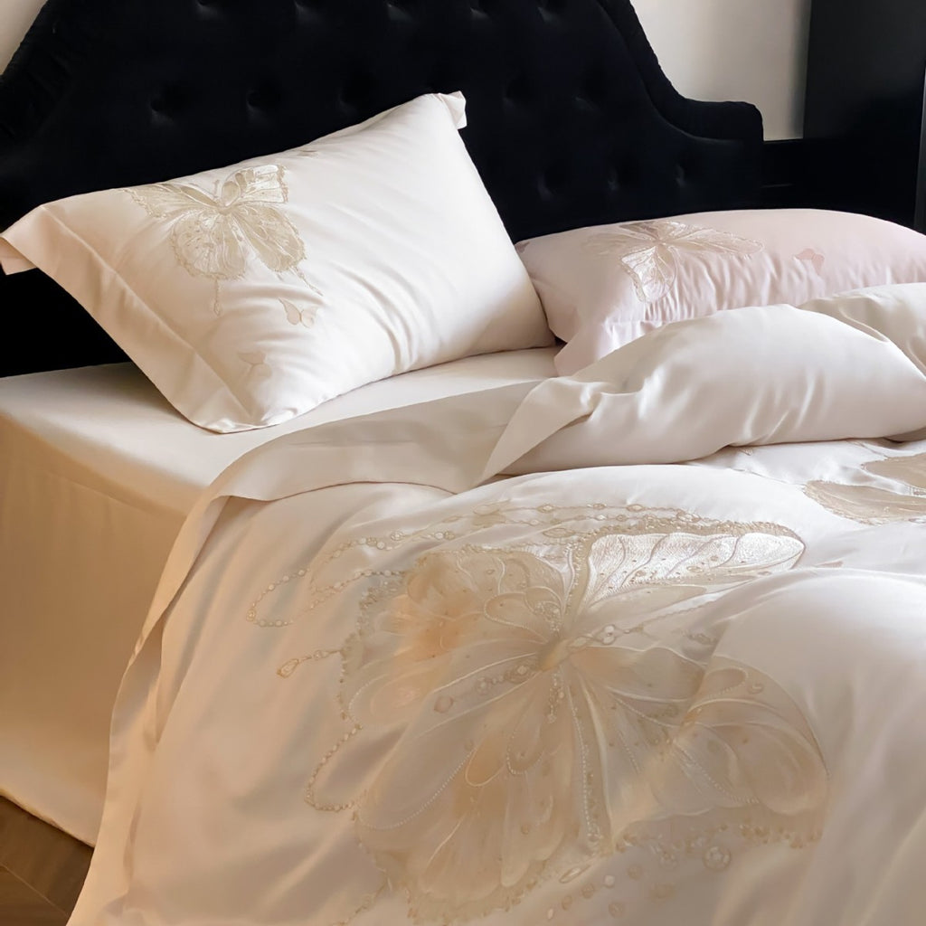 Luxurious satin bedding set with embroidered butterfly motifs and silky glossy finish
