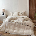 Home decor bedding set made of organic linen with hand-embroidered swallow motif and wavy hem