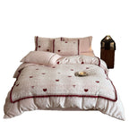 Quilted bedding set with heart and bow appliqué