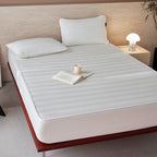 Breathable mattress topper with non-slip bottom and moisture-regulating structure