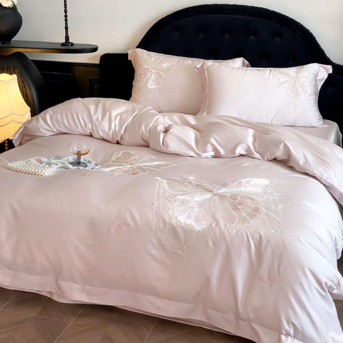Luxurious satin bedding set with embroidered butterfly motifs and silky glossy finish