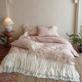 Bedding set with pleated frill, lace border, and floral print