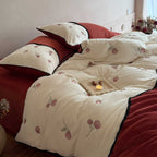 Embroidered bedding set with rose embroidery and contrasting piping