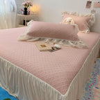 Quilted bedspread with ruffle and delicate floral quilting