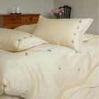 Embroidered cotton satin bedding set with subtle floral scatter design