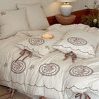Romantic cotton-linen bedding set with embroidered flower medallions and ruffles