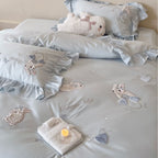 Satin bedding set with ruffles, embroidered bunny appliqués and silky-smooth finish