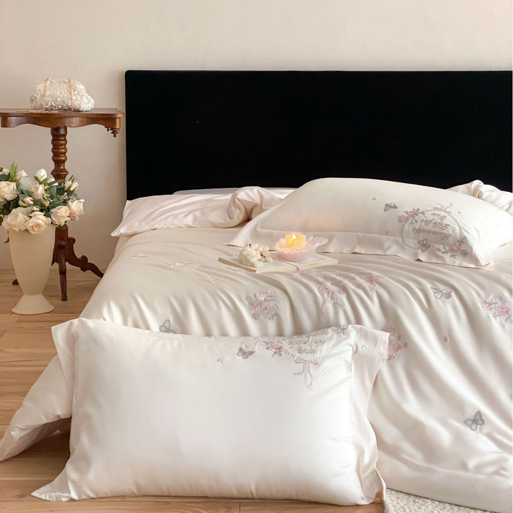 Luxurious embroidered cotton satin bedding set with delicate butterfly and flower appliqués