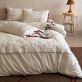 Embroidered bed linen set with lace trim and decorative bows