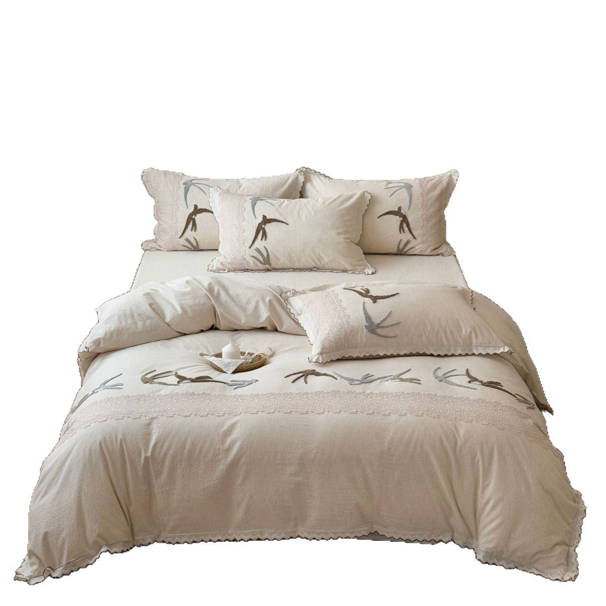 Home decor bedding set made of organic linen with hand-embroidered swallow motif and wavy hem