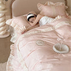 Duvet cover set with ruffle trim, fine lace border, and subtle jacquard structure