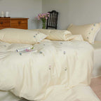 Embroidered cotton satin bedding set with subtle floral scatter design