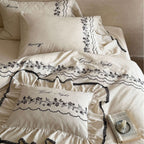 Bedding set with embroidered ruffles and linen look