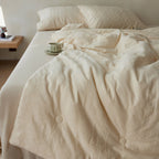 Quilted duvet cover made of linen-cotton mix with subtle textured embroidery and button tufting