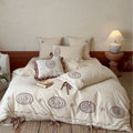 Romantic cotton-linen bedding set with embroidered flower medallions and ruffles