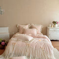 Romantic bedding set made of cotton satin with quilted duvet cover, decorative ruffled trim and bow appliqués
