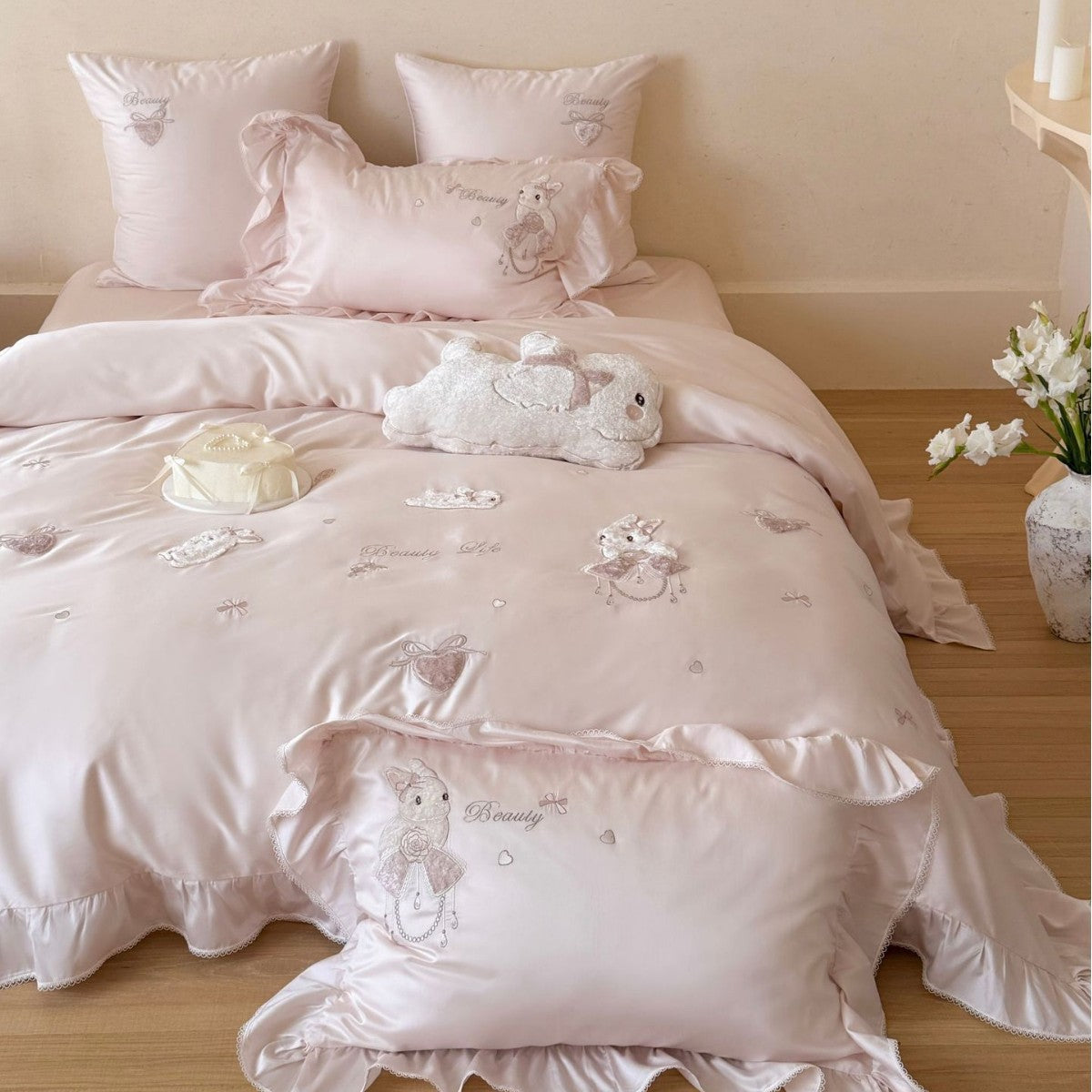 Satin bedding set with ruffles, embroidered bunny appliqués and silky-smooth finish