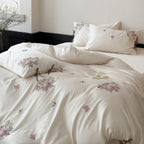 Silky-matte satin bedding set with embroidered rose bouquets and ties