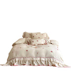 Bedding set made of cotton percale with frill hem, floral embroidery, and decorative ribbons